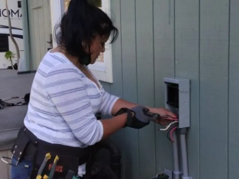 Licensed electrician wiring an exterior subpanel in Greenwich